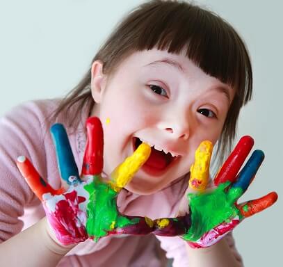 child with paint on their hands